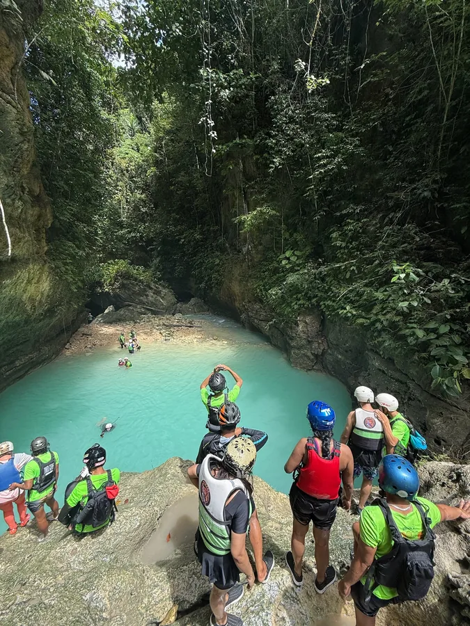 Canyoneering at a turquoise river pool in the Philippines